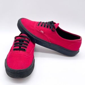 Red and black Vans classic laced shoes.